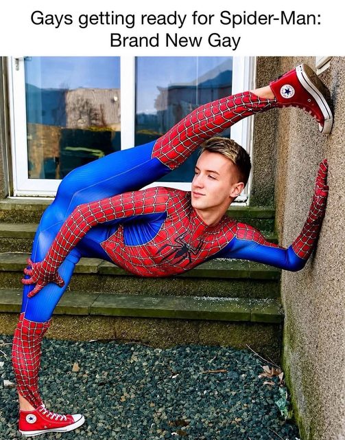 A young man in a Spider-Man costume and red sneakers strikes a flexible pose outdoors.