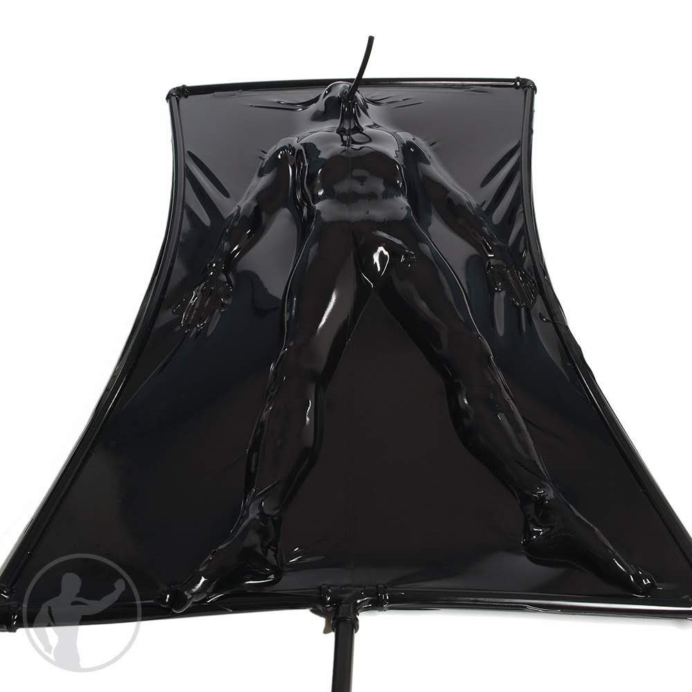 A person is fully encased in a black latex vacuum suit.